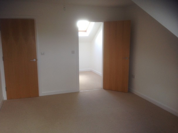 Master bedroom with door leading to dressing area.