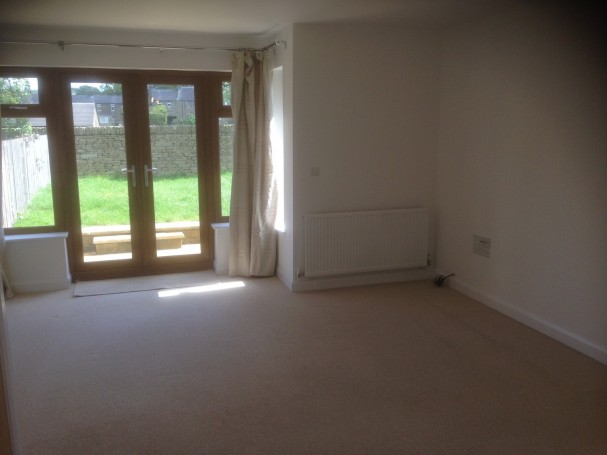 Spacious living room with French doors.