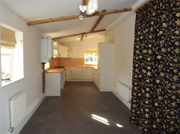 Spacious kitchen and dining area with exposed beams. Spacious kitchen and dining area with exposed beams.