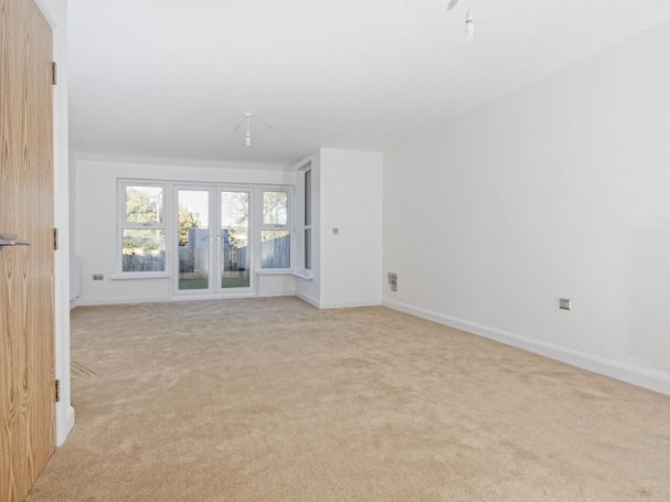 Spacious lounge leads out to large garden through double patio doors.